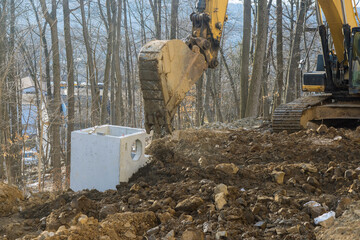 Heavy excavator excavating soil working during road works, moving soil during construction of the new road