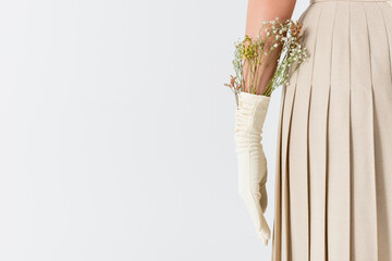 cropped view of woman in glove with flowers isolated on white