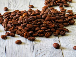 coffee beans on wooden background. fresh coffee beans on wooden white background