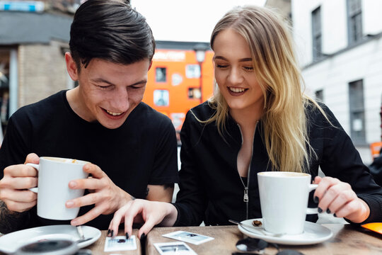Young Couple at the Coffee Shop Drinking a Cappuccino