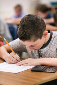 Classroom: Male Student Takes Math Test With Calculator