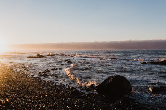 A west coast sunrise on the shoreline of the ocean - Powered by Adobe