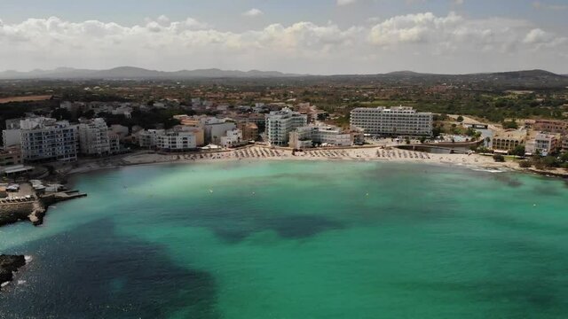 Retreating aerial of clear water off Cala Moreia of S'illot, Mallorca