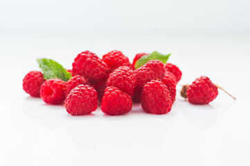 Ripe raspberry with leaves isolated on white background