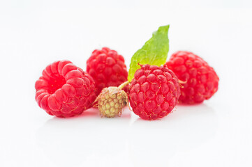Ripe raspberry with leaves isolated on white background
