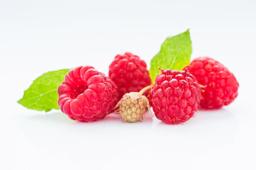 Ripe raspberry with leaves isolated on white background