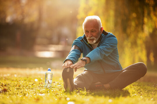 Senior man stretching in the park