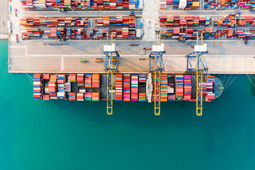 Fototapeta na wymiar Aerial top view Of Containers cargo ship. Business logistic transportation sea freight, Cargo ship, Cargo container in deep sea port at industrial estate for import export around in the world