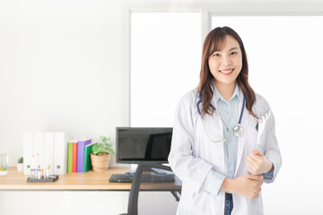 asian female doctor stand in clinic office, she holding patient chart and order medicine  in hospital, treatment  information