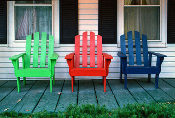 Colorful Adirondack Chairs on the Porch of a House