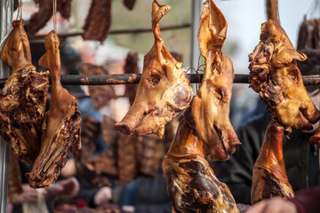Head of a smoked pig, a young one, on display in Serbia, in the Balkans, used as cured meat. Porks are traditionnaly smoked on this kind of skewers in the Serbian coutryside.