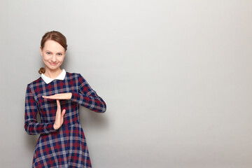 Portrait of happy girl showing timeout gesture with hands and smiling