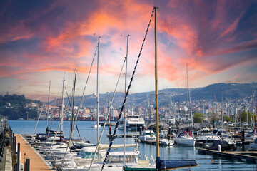 boats in the port of vigo with sunset and blue sea.
