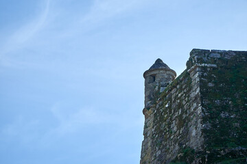medieval castle wall with blue sky in background. castle with cloudless sky - Powered by Adobe
