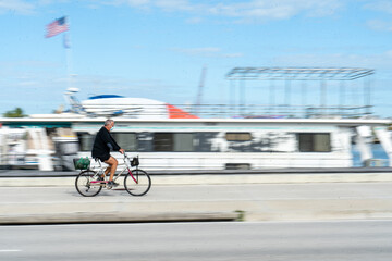 Man on Bicycle Wearing Mask with Motion Blur 
