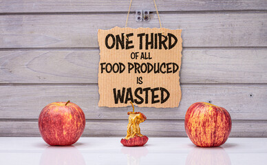 One third of all food is wasted text, 3 apples, one rotten to illustrate estimated global food...