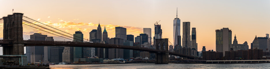 Manhattan Skyscrapers and Brooklyn bridge at dusk in New York, USA