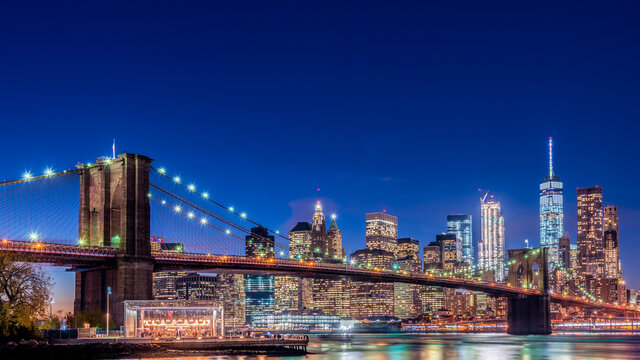 Magic Hour View Of Manhattan Skyscrapers And Brooklyn Bridge In New York, USA