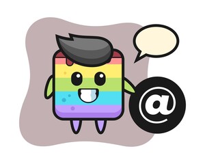 Cartoon illustration of rainbow cake standing beside the At symbol