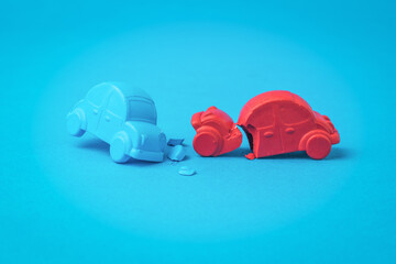 An accident between a red and blue car on a blue background.