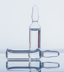 Glass medical ampoule vial for injection. Medicine is dry white drug penicillin powder or liquid...