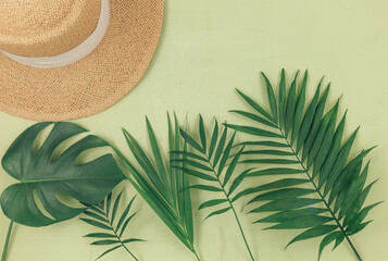 Tropical palm leaves on green background. Trendy tropical pattern. Flat lay. Summer, vacation, holidays concept.	
