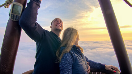 Adventure love couple on hot air balloon watermelon. Man and woman kiss hug love each other. Burner...
