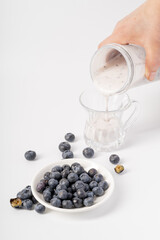 Healthy nutritious breakfast blueberry milkshake on white background