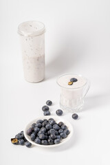 Healthy nutritious breakfast blueberry milkshake on white background