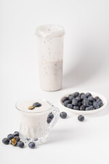 Fototapeta na wymiar Healthy nutritious breakfast blueberry milkshake on white background