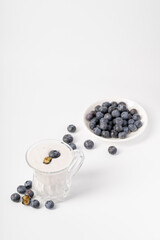 Healthy nutritious breakfast blueberry milkshake on white background