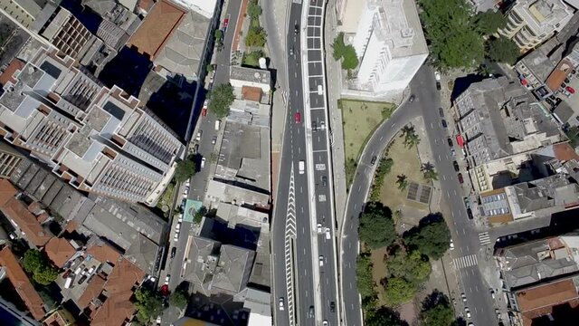 Aerial view of Minhoc&atilde;o, an elevated road in downtown Sao Paulo, on a sunny day. Slow til up shot.
