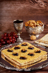 Matzo cake with silver kiddush cup and walnuts.