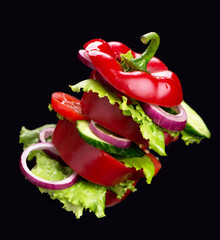 Creative layout made of bell pepper, cucumber and salad leaves.Food concept.