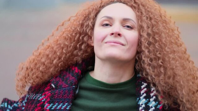 beautiful young woman looking at camera and smiling joyfully. Happy face on street at sunlight. Positive portrait outside. Close up. Slow motion video. stock footage