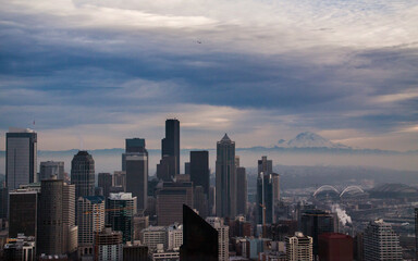dramatic sunset in Seattle skyline with Mt. Rainier on the background.