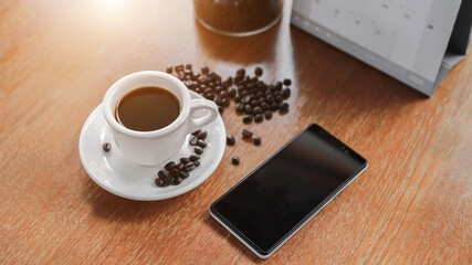mobile, coffee cup Placed on an old wooden table is a planning idea for success.