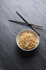 Asian traditional cuisine on black background. Traditional Asian noodles, flat lay, Asian chopsticks.