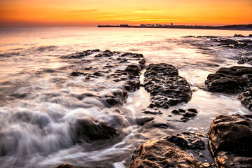 Fototapeta na wymiar beautiful dramatic sunset in the shores of Swansea,Wales