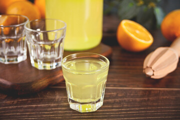 Italian drink lemon liqueur limoncello in glasses on the wooden table