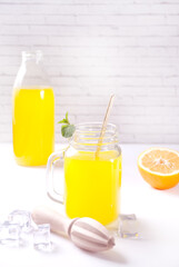 Jar of fresh lemonade. Sliced lemon on background.