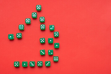 Thumb up made of many green game dices on red background with space for text: concept of table board games from the whole family, top view