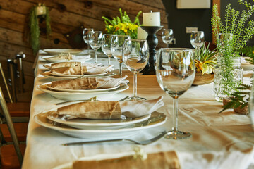 Laid table with cutlery and crockery in the sunset sunlight