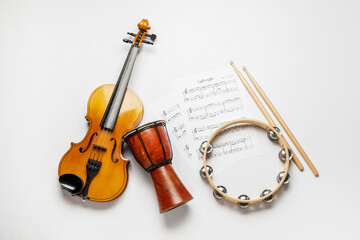 Different musical instruments and music notes on white background