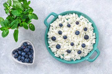 Cottage cheese with berries and mint. Cottage cheese in a bowl. Top view. Dairy products.