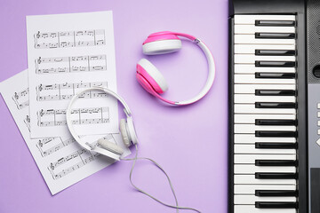 Modern synthesizer, headphones and music notes on color background