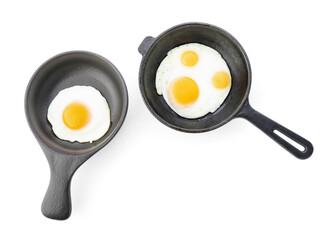 Pans with tasty fried eggs on white background