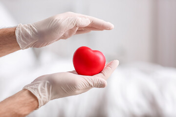 Cardiologist with red heart in clinic