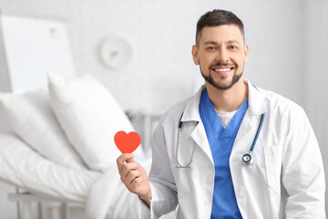Cardiologist with red heart in clinic