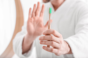 Man refusing to brush teeth in morning